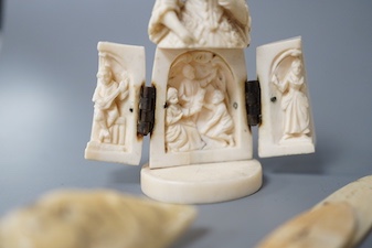 A pair of 19th century ivory balm pots, 3.75cm., a smallDieppe triptych figure, 6.5cm. a Meiji tiger brooch and a Dutch page marker.